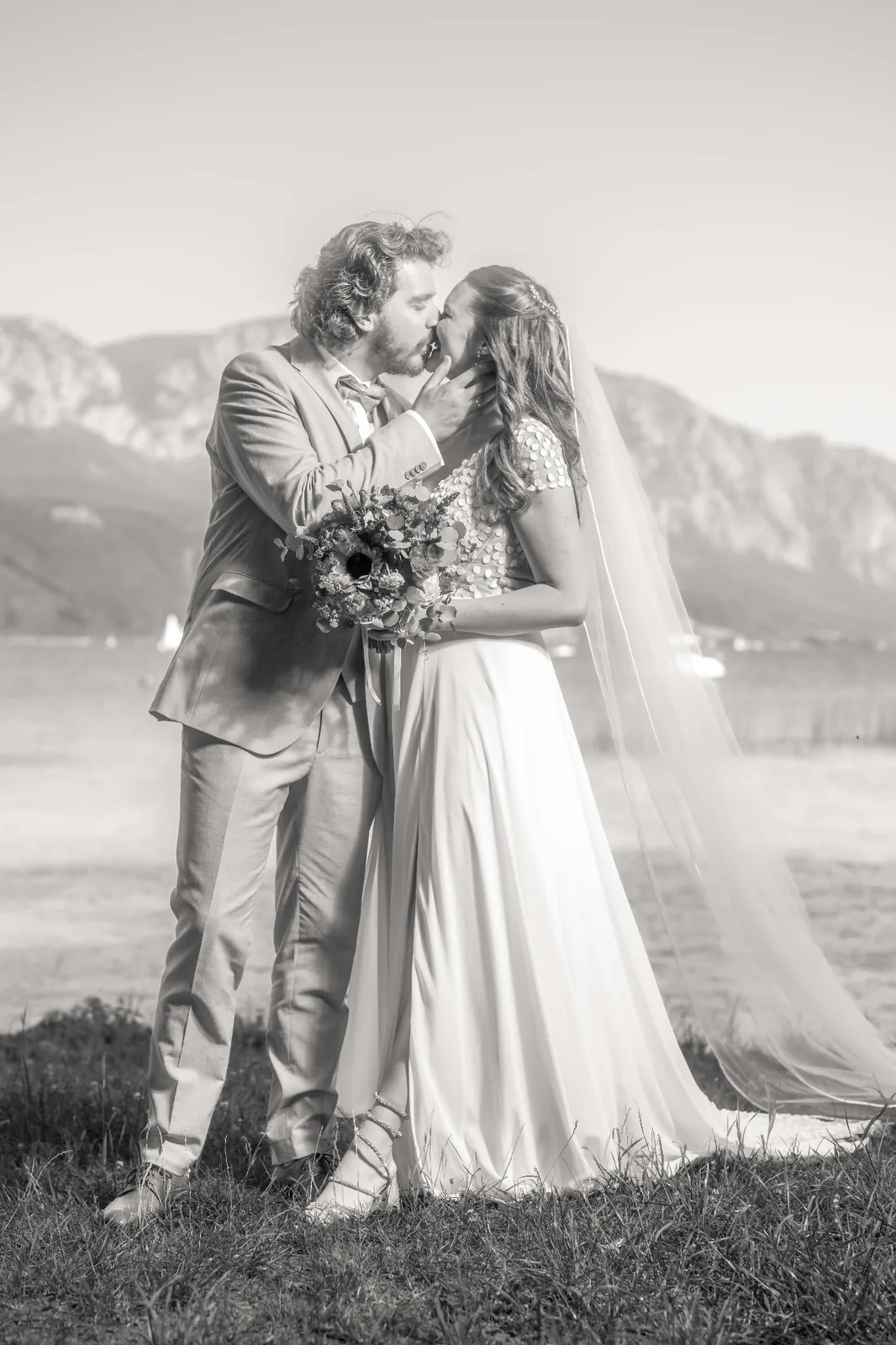 Bride and groom embracing at the lakeside