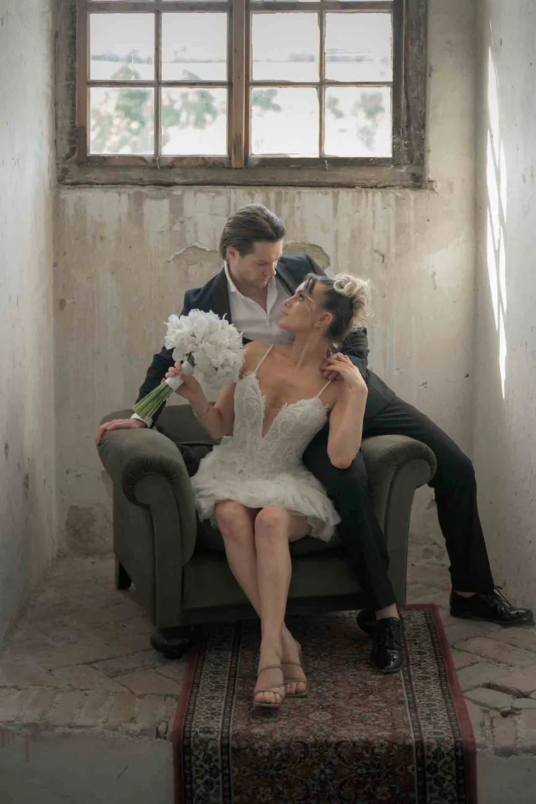Bride and groom sitting together in a historic room at Schloss Haggenberg — timeless editorial wedding photography in the Weinviertel