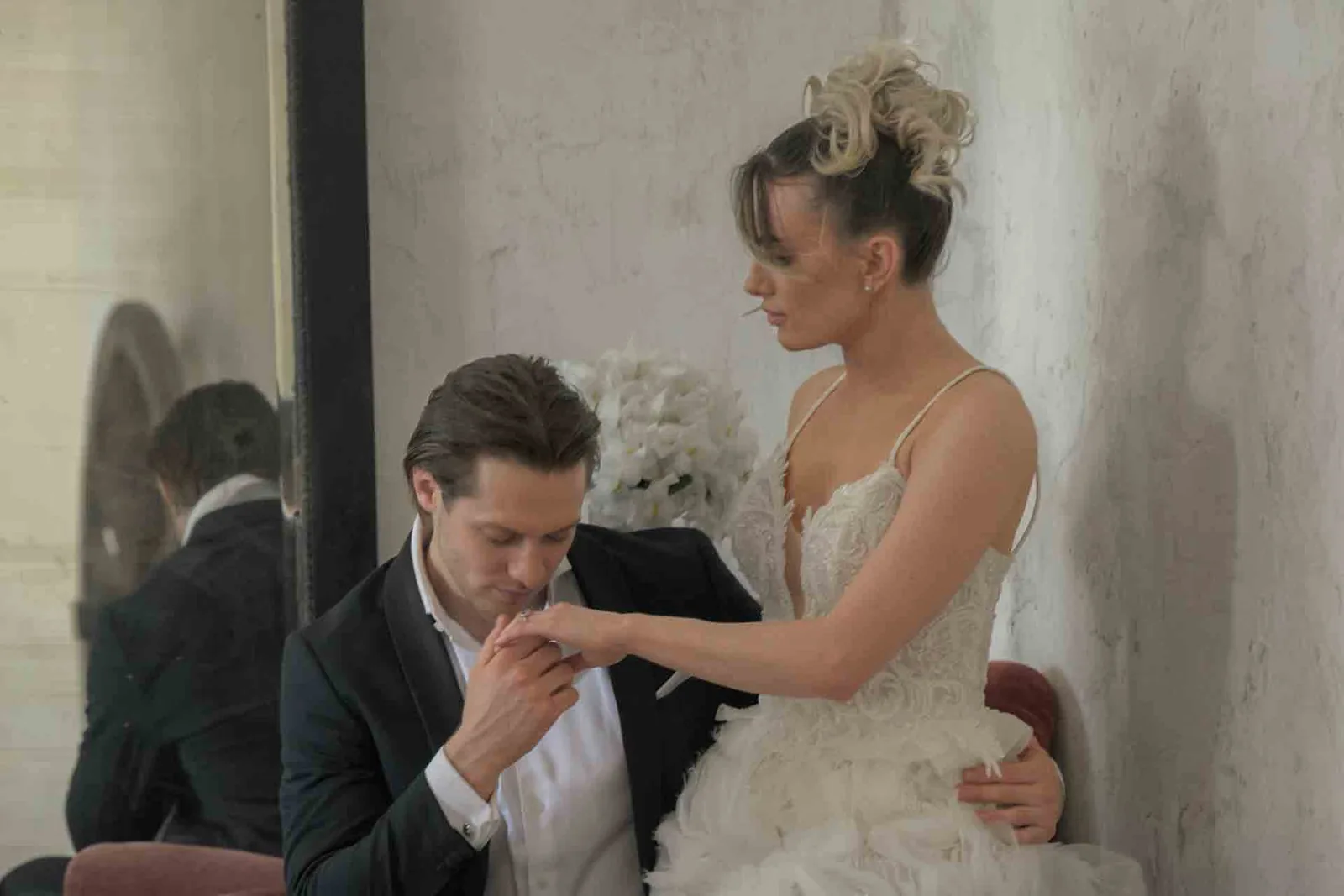 Groom kissing the bride's hand during an intimate couple moment at Schloss Haggenberg — emotional wedding photography Lower Austria