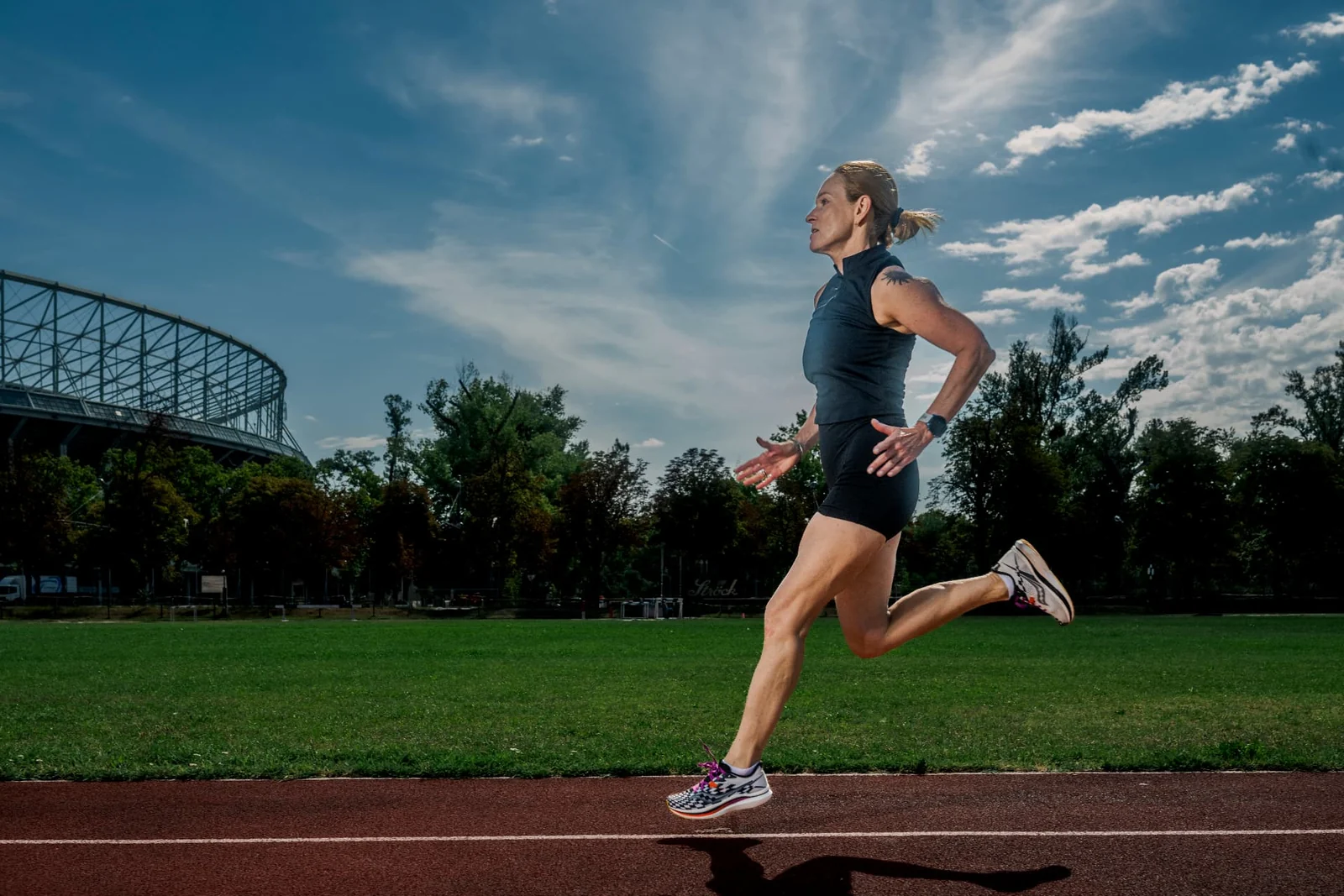 Birgit Pfeifer running beneath an open sky in Vienna