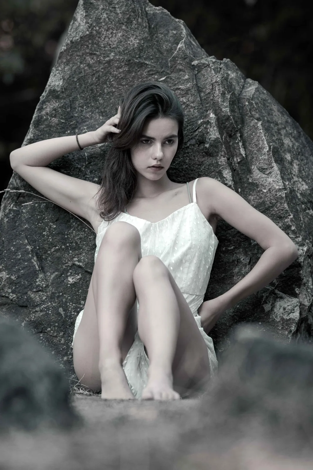 Quiet fine-art portrait of Tiana in front of a tall stone of the stone circle on the Donauinsel