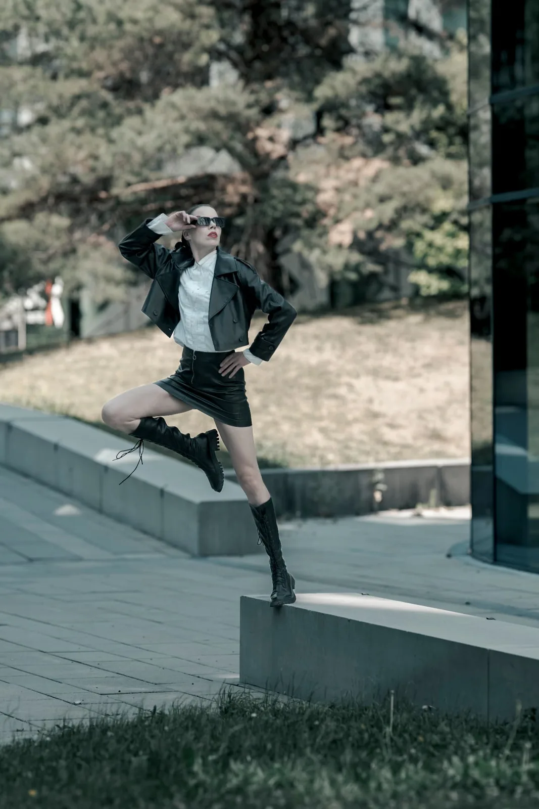 Model Denisa Strakova mid-movement in daylight on a concrete plaza near Messe Wien, photographed without artificial light.