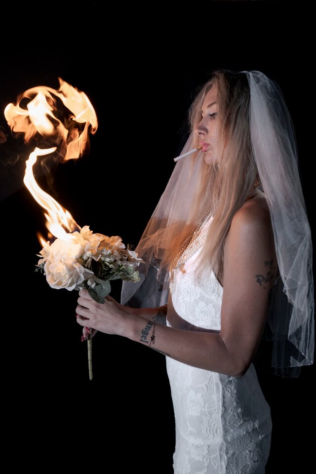 Avant-garde bridal fashion portrait with a veil and burning bouquet, photographed by Peter Scholz for SCHOPHO.