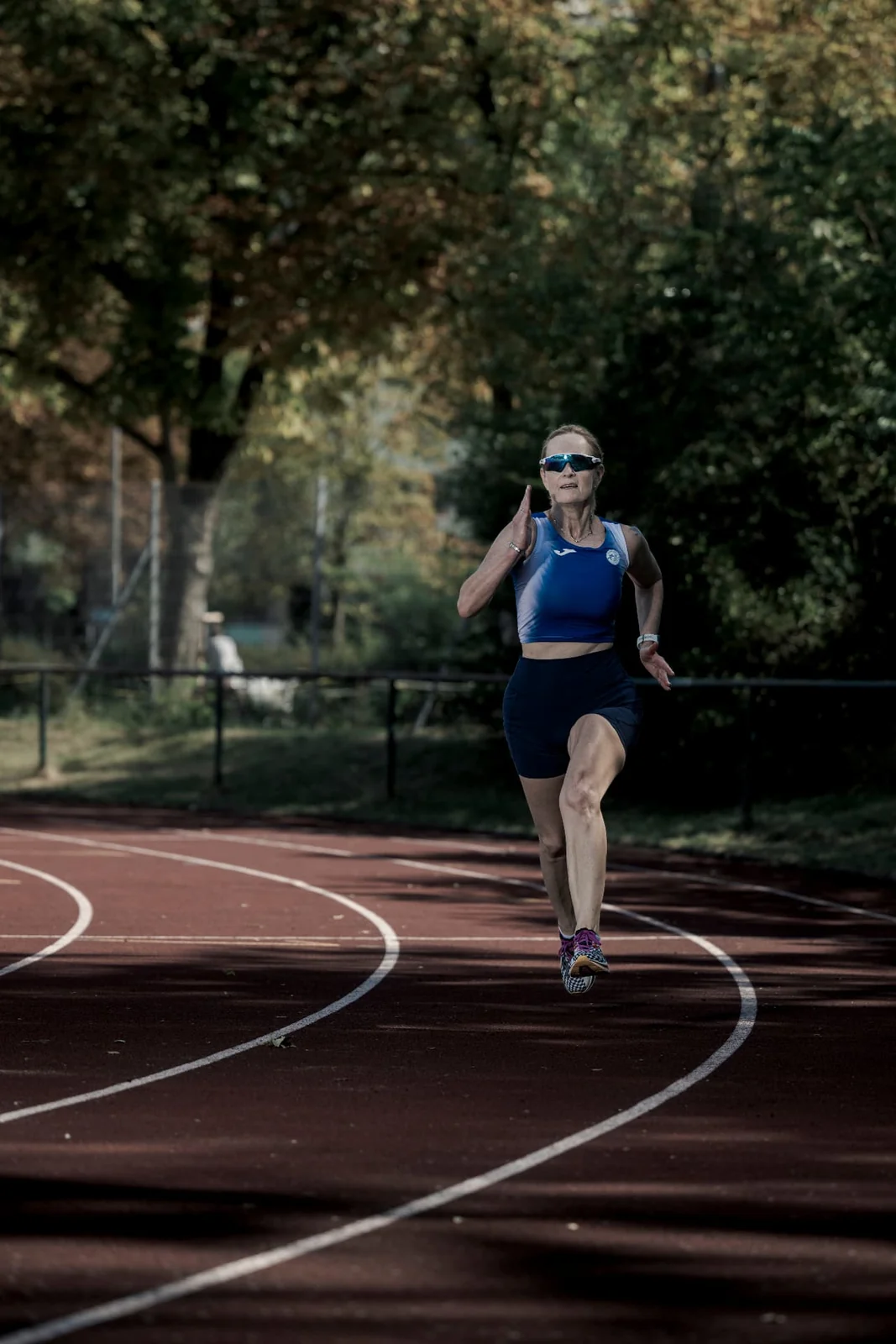 Runner Birgit Pfeifer between the curved lines of a track