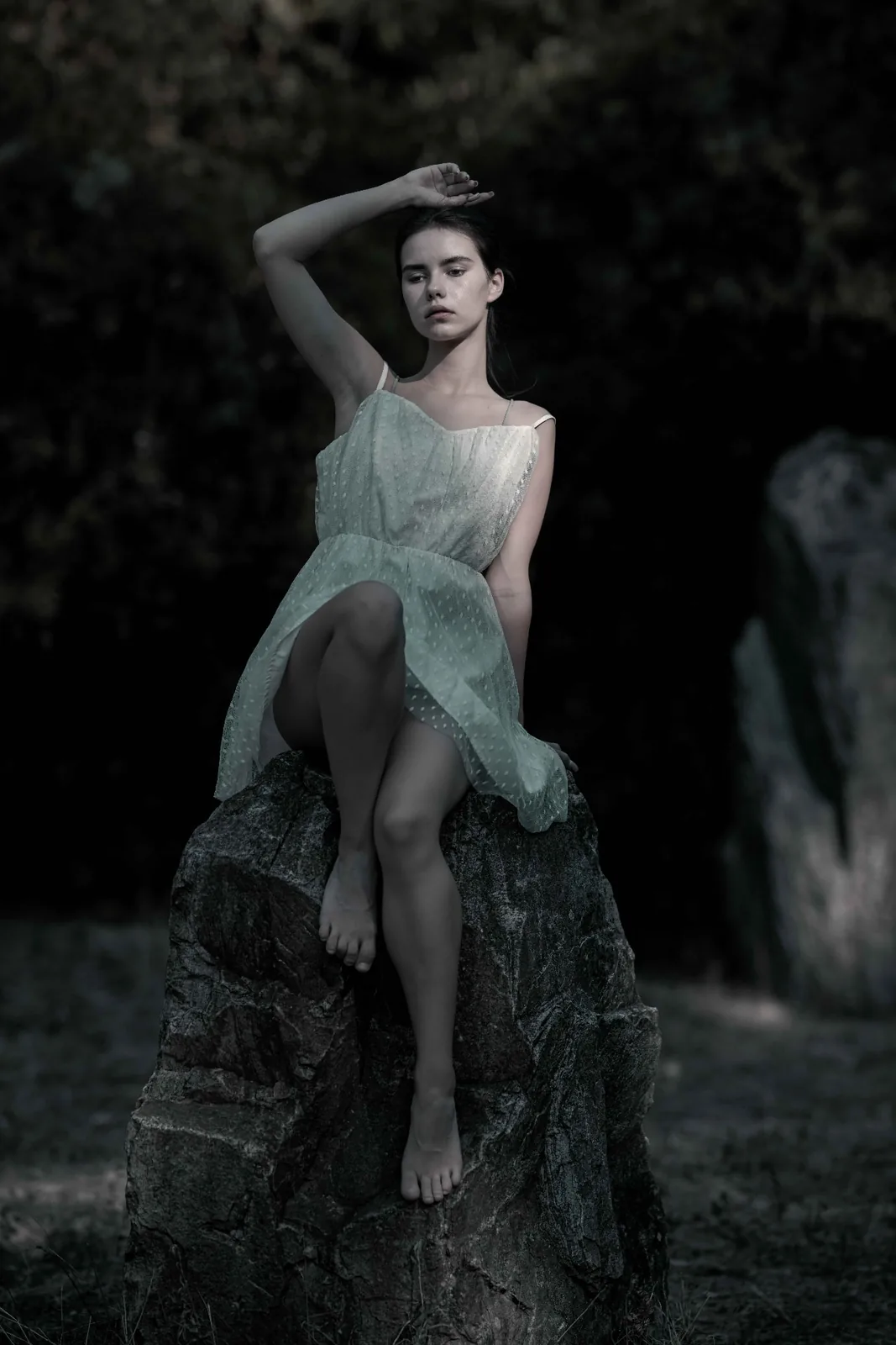Tiana on a monolith of the stone circle on the Donauinsel, surrounded by woodland