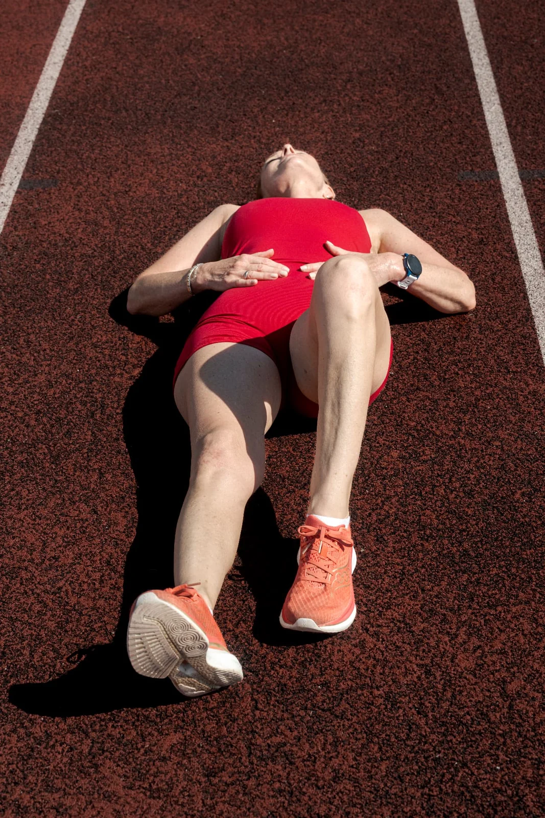 THE ART OF RUNNING Runner Birgit Pfeifer in a red running dress on a track in Vienna