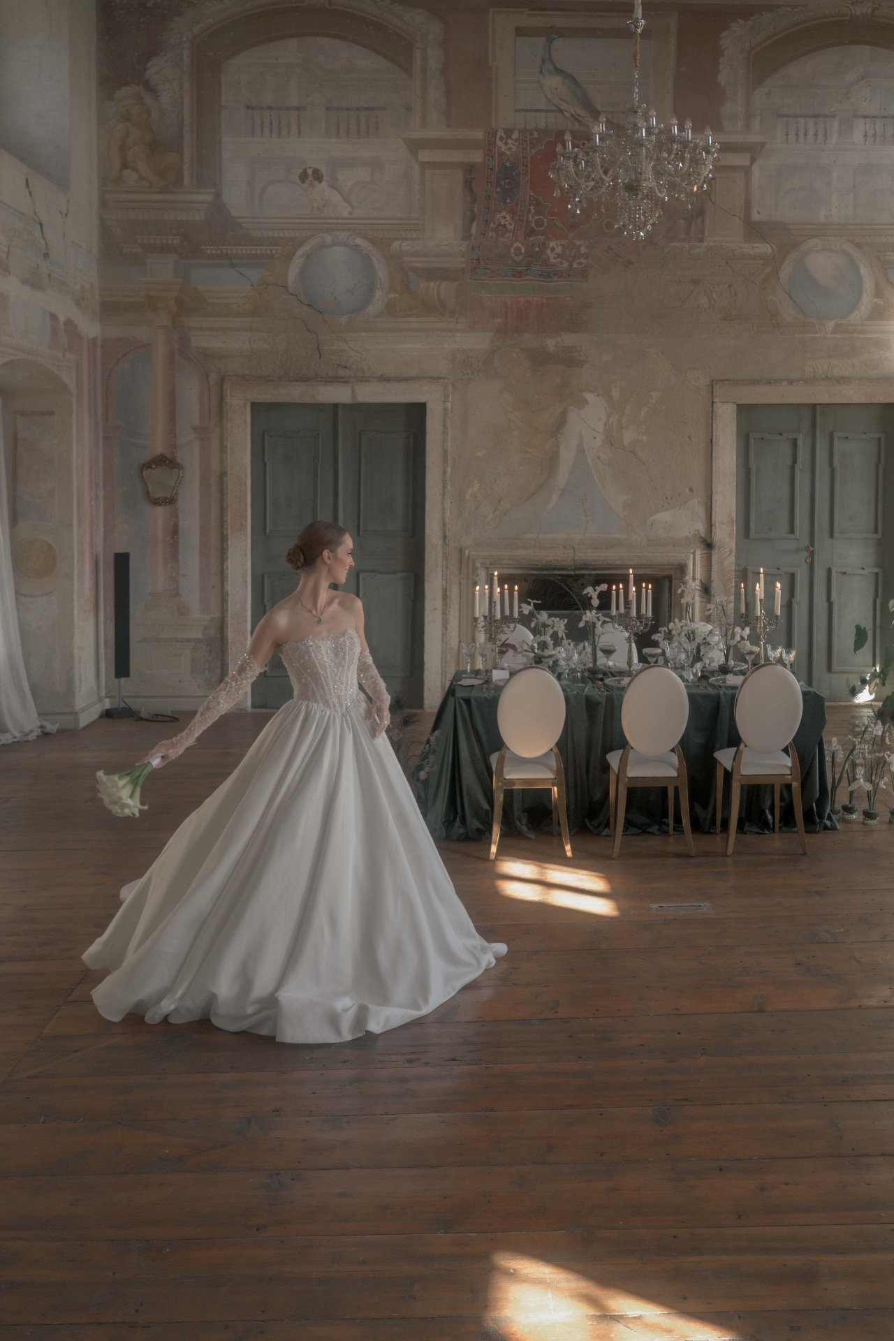 Wide format editorial wedding image of the ballroom at Schloss Haggenberg with frescoed walls and chandelier — Fine Art Wedding Photography by Peter Scholz