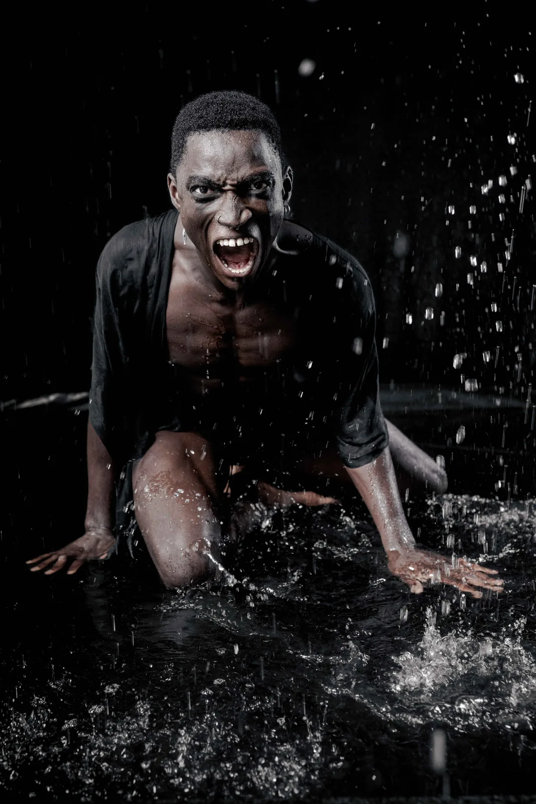 Second frame of Kevin shouting in water, motion and spray in low-key light.