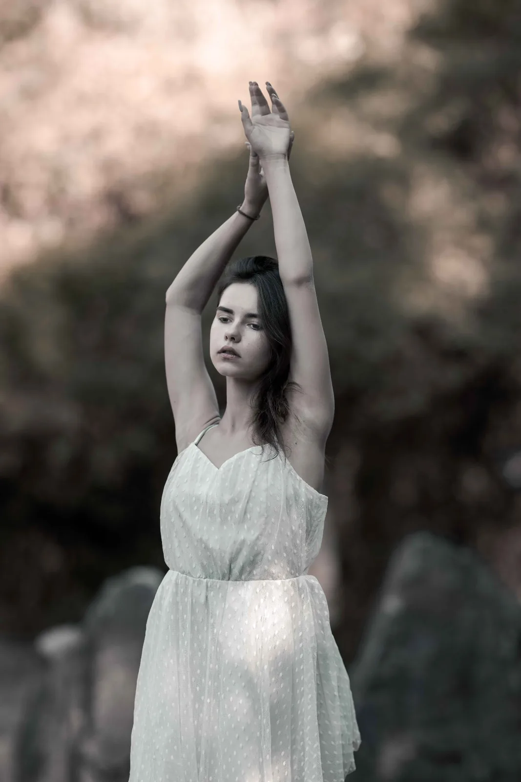 Tiana with raised arms among the stones of the stone circle on the Donauinsel