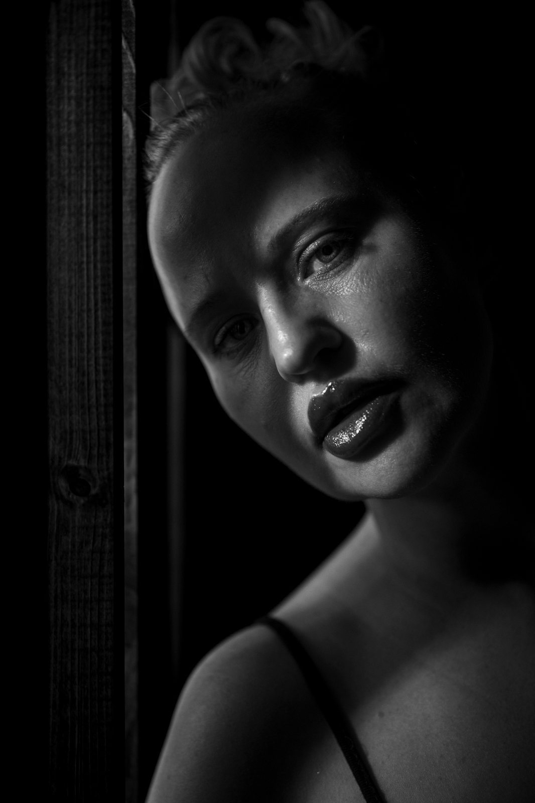 Black and white Fine Art portrait created with one soft light source and dramatic shadow design.