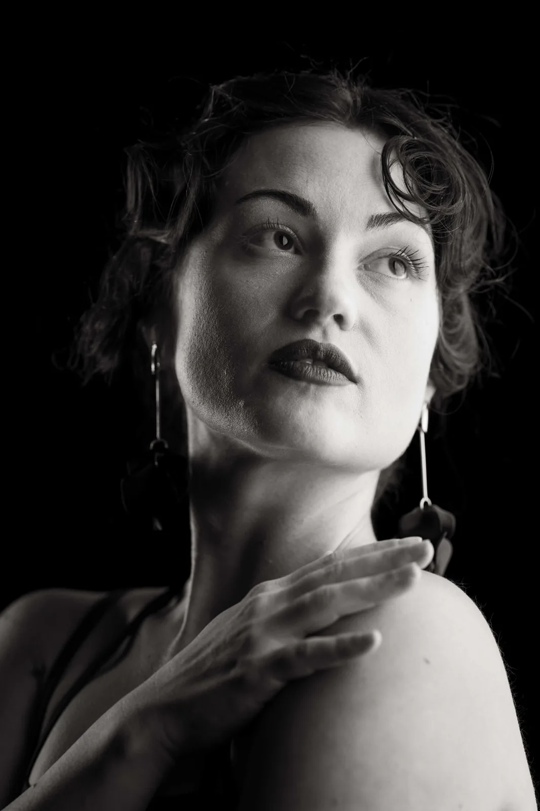 Intimate black and white studio portrait — close-up of lips and jawline, sculpted by soft directional light, from the editorial series Monochrome Presence